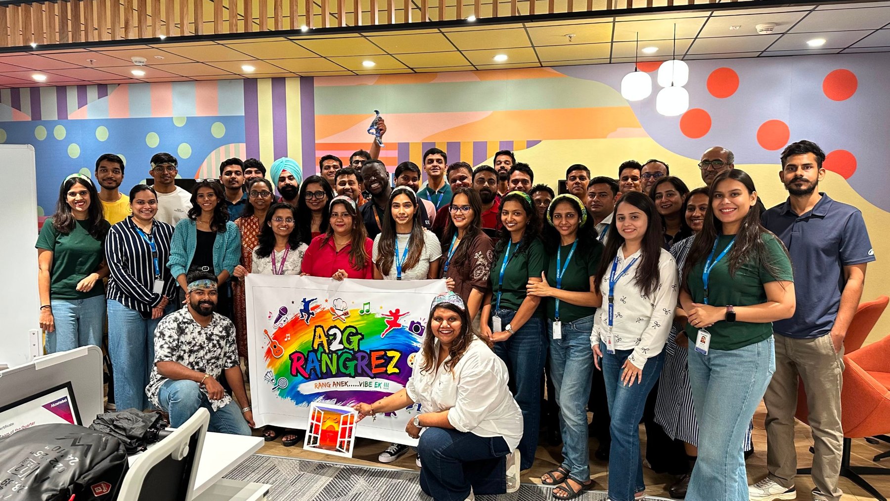 The A2G Rangrez team holding a rainbow banner reading Rang Anek, Vibe Ek